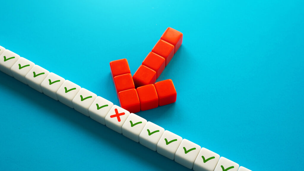 White dice with a red "x" singled out among a row of dice with green check marks to represent the identification of a piece of technology in the stack that's underperforming.